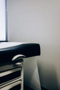 A black and white table with a black cushion.