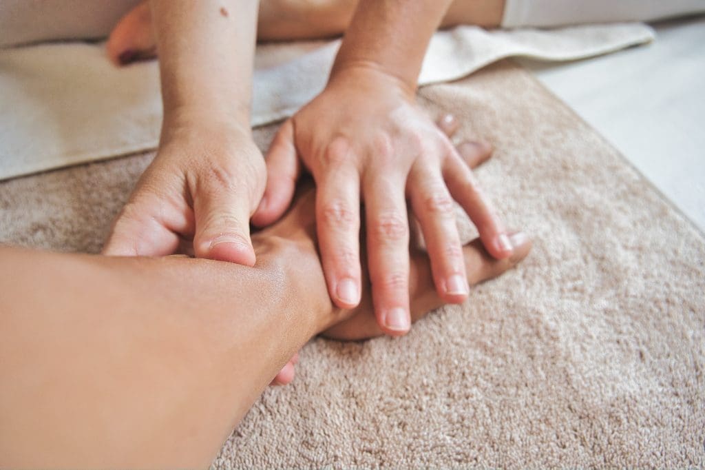 A woman is getting a massage on her foot.