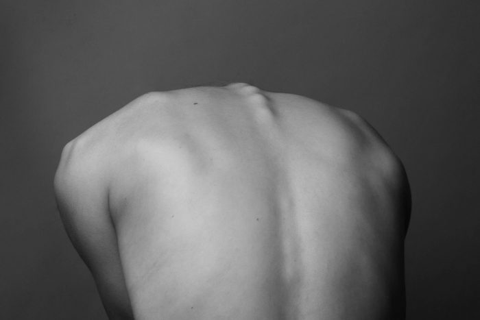 A black and white photo of a woman's back.