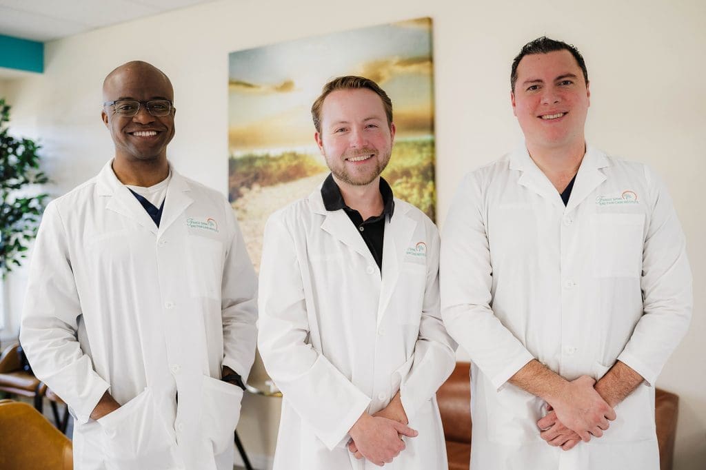 A group of men in white lab coats.