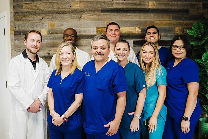 A group of people in blue scrubs.