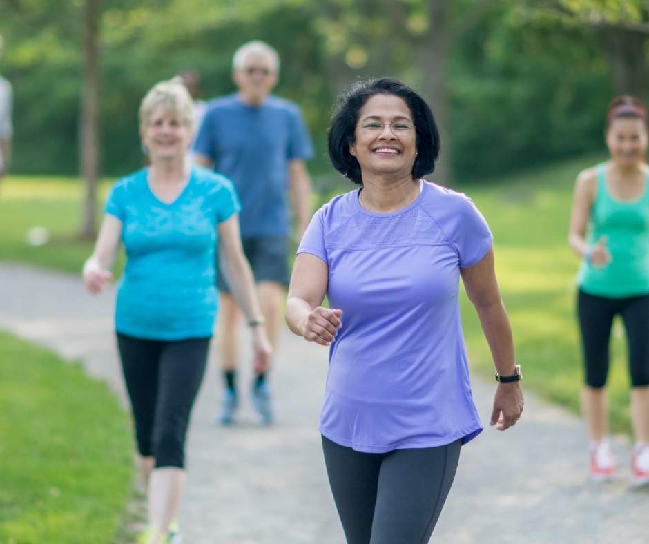 A group of people running in a park.