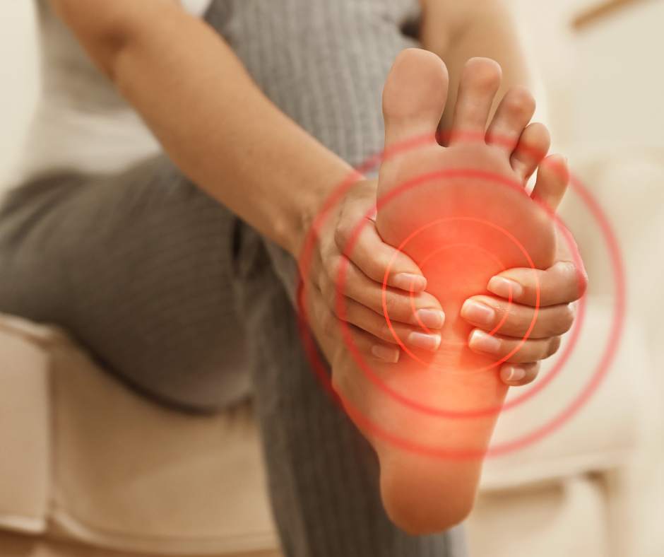 A woman's foot with a red light on it.