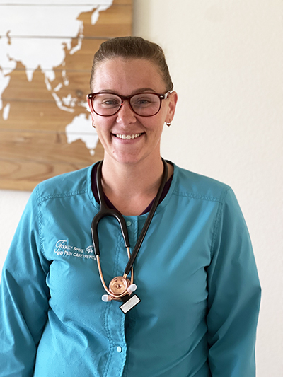 A woman wearing a stethoscope around her neck.